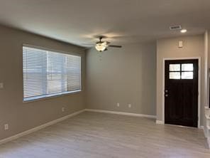 entrance foyer featuring baseboards, ceiling fan, and wood finished floors