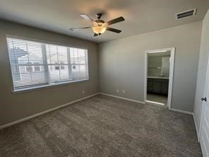 unfurnished bedroom featuring visible vents, baseboards, carpet floors, and ensuite bath