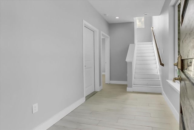 stairs featuring recessed lighting, baseboards, and wood finished floors