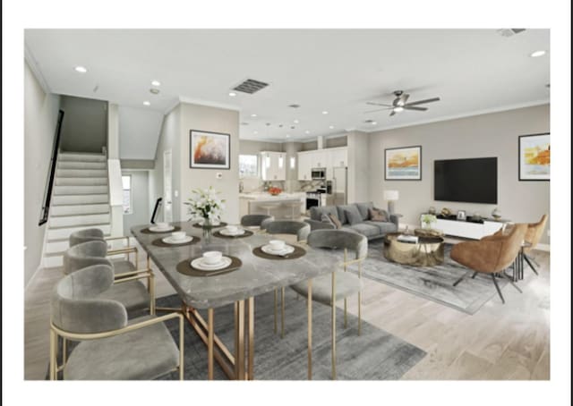 dining area featuring recessed lighting, light wood finished floors, stairs, and a wealth of natural light