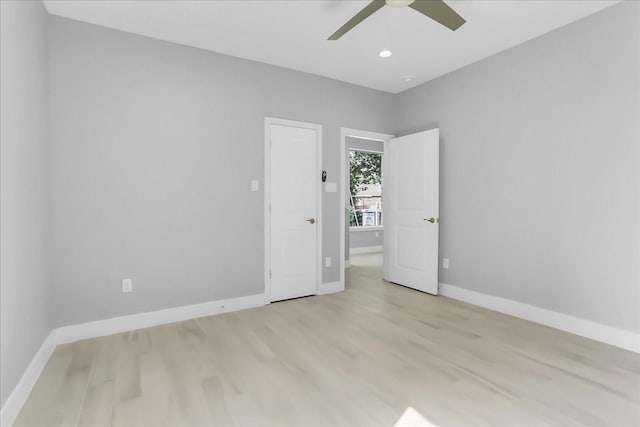 spare room with baseboards, ceiling fan, recessed lighting, and wood finished floors