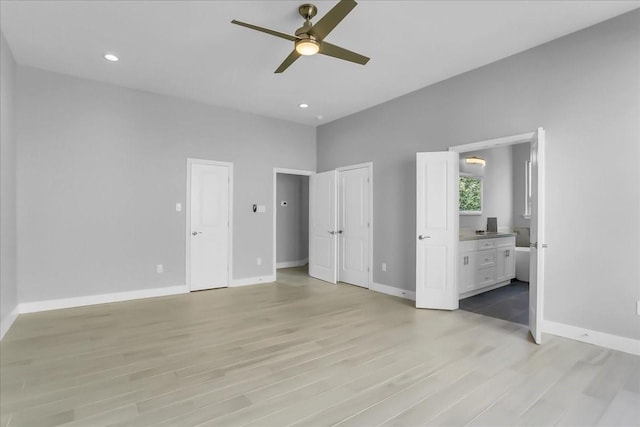 unfurnished bedroom with baseboards, recessed lighting, a ceiling fan, light wood finished floors, and ensuite bath
