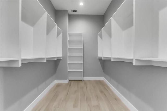 spacious closet with visible vents and light wood-type flooring