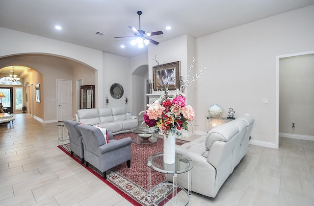 living room featuring arched walkways, recessed lighting, and ceiling fan