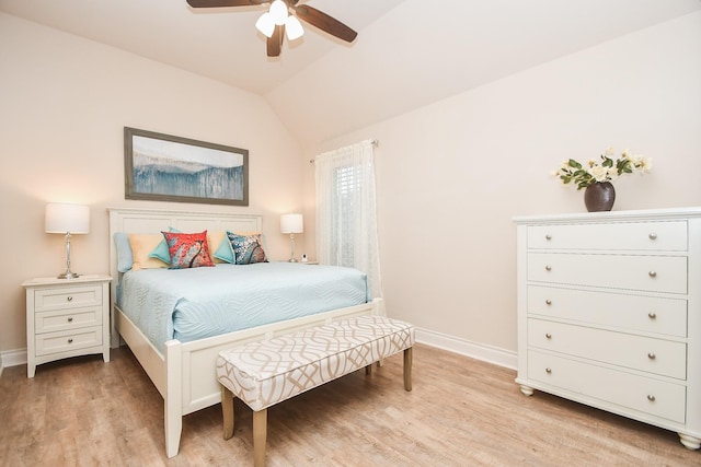 bedroom with baseboards, light wood finished floors, a ceiling fan, and vaulted ceiling