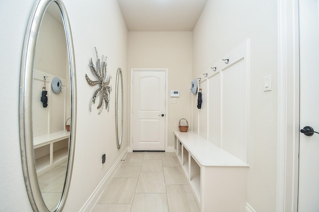 mudroom with baseboards and light tile patterned flooring