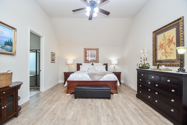 bedroom featuring vaulted ceiling, light wood-style flooring, and baseboards