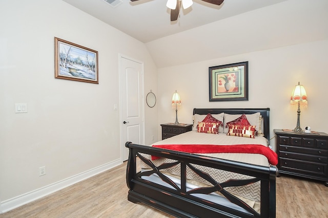 bedroom featuring ceiling fan, light wood-style flooring, baseboards, and lofted ceiling