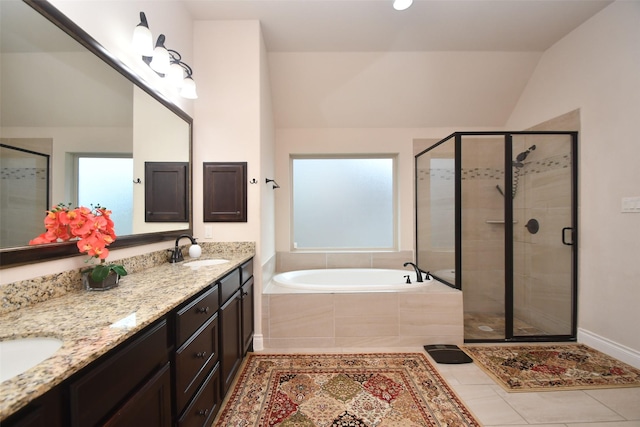 full bathroom with a sink, lofted ceiling, a stall shower, double vanity, and a garden tub