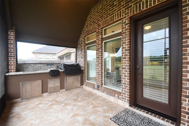 view of patio with covered porch, exterior kitchen, and a sink