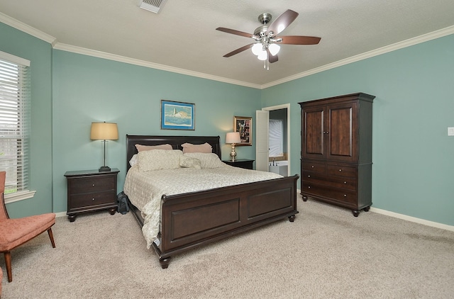 bedroom featuring ceiling fan, visible vents, crown molding, baseboards, and light carpet