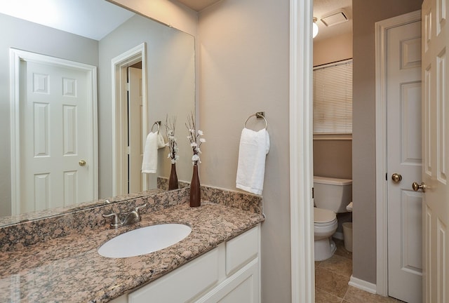 bathroom featuring toilet, tile patterned floors, and vanity