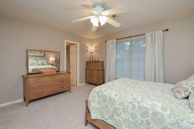 bedroom featuring baseboards, a ceiling fan, and light colored carpet