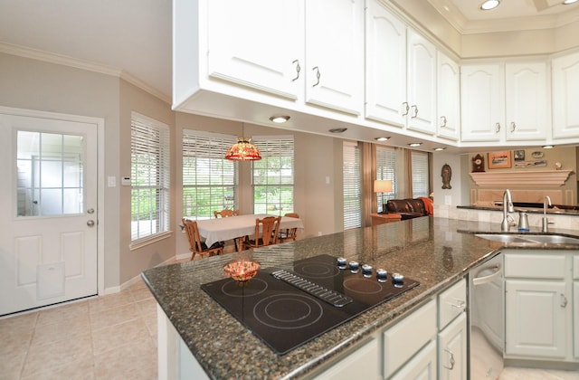 kitchen featuring dark stone counters, black electric cooktop, white cabinetry, and ornamental molding