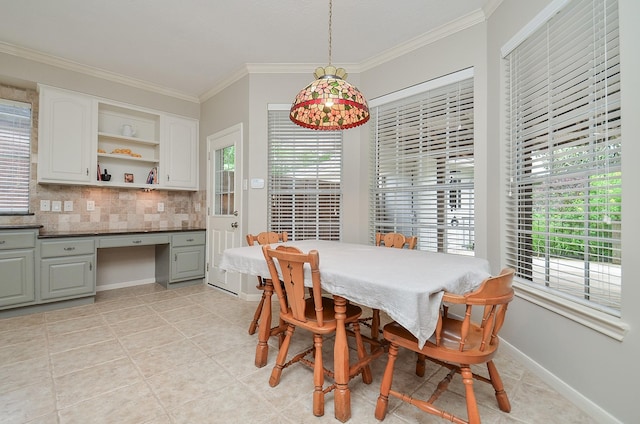dining area featuring a healthy amount of sunlight, light tile patterned floors, ornamental molding, and built in desk