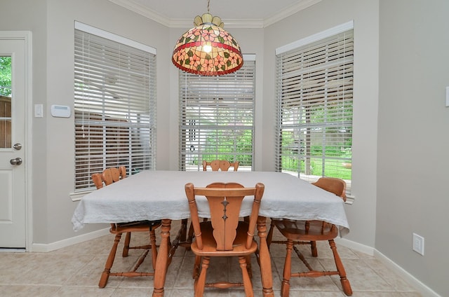 dining room with crown molding, baseboards, plenty of natural light, and light tile patterned floors