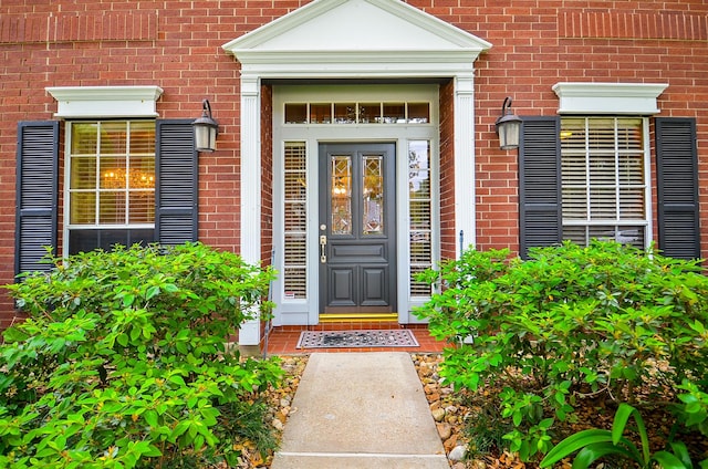 property entrance featuring brick siding