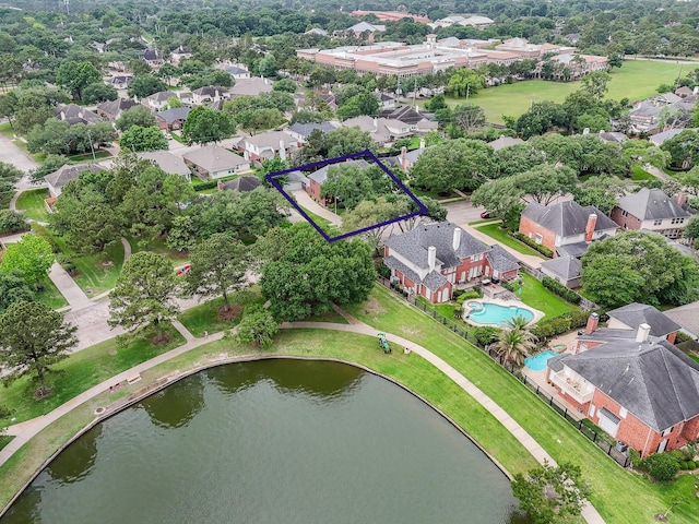 birds eye view of property featuring a water view and a residential view