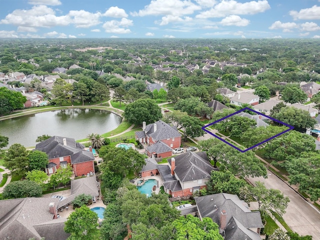 birds eye view of property with a water view and a residential view