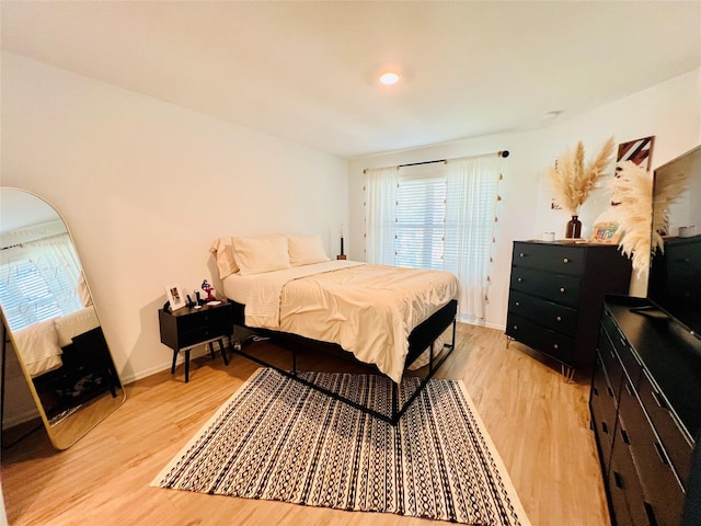 bedroom featuring light wood-style floors and multiple windows
