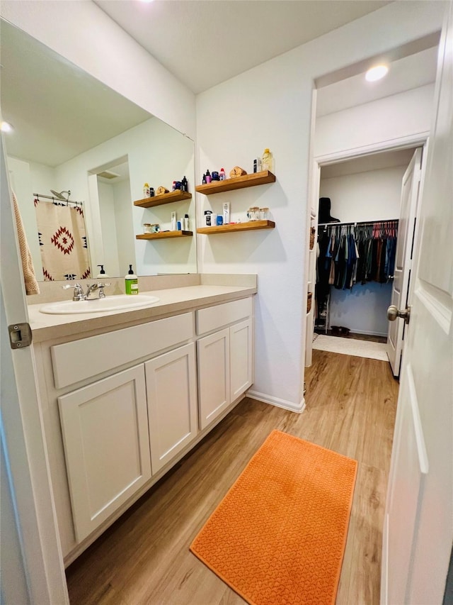 14410 Boyton Hollow Trce, Rosharon, TX 77583 - bathroom featuring vanity, wood finished floors, curtained shower, recessed lighting, and a spacious closet