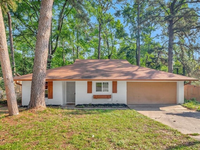 single story home with fence, roof with shingles, a garage, a front yard, and concrete driveway