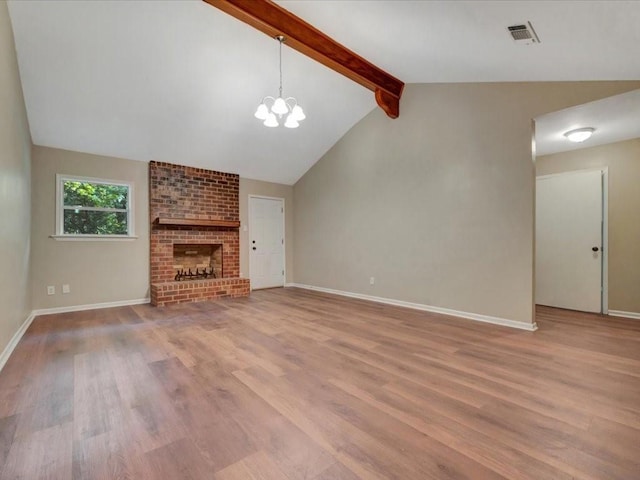 unfurnished living room featuring a chandelier, baseboards, vaulted ceiling with beams, wood finished floors, and visible vents