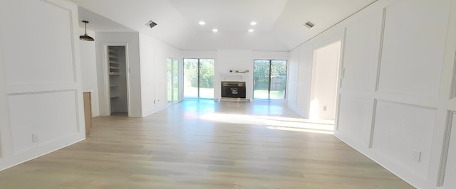 7619 Apache Plume Dr, Houston, TX 77071 - unfurnished living room featuring light wood-type flooring, lofted ceiling, recessed lighting, a decorative wall, and baseboards