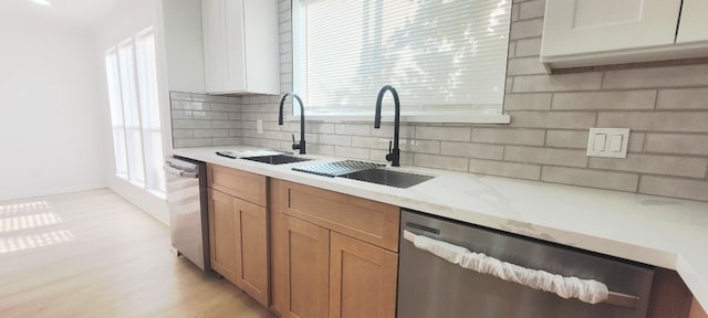 7619 Apache Plume Dr, Houston, TX 77071 - kitchen featuring dishwasher, tasteful backsplash, light wood-style floors, and healthy amount of natural light