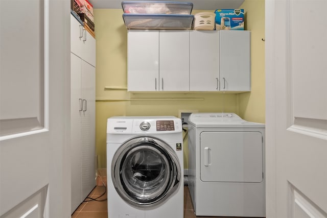 4811 Saxon St, Bellaire, TX 77401 - washroom featuring tile patterned floors, cabinet space, and independent washer and dryer