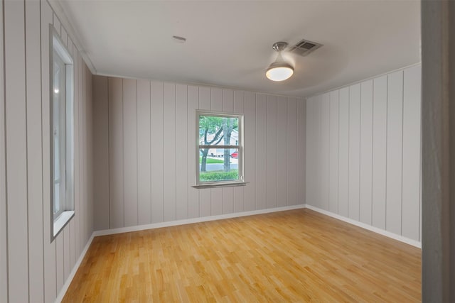 4811 Saxon St, Bellaire, TX 77401 - unfurnished room featuring baseboards, visible vents, and light wood-style flooring