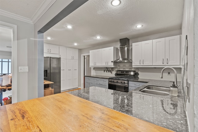 4811 Saxon St, Bellaire, TX 77401 - kitchen with a sink, wall chimney exhaust hood, a textured ceiling, and stainless steel appliances