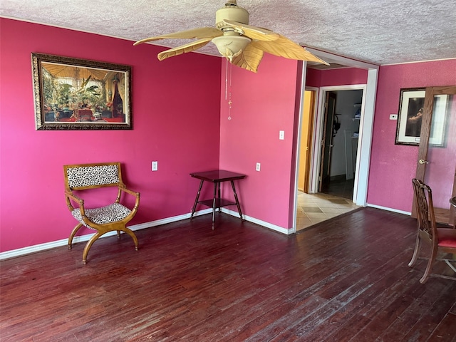 1130 Hoffman St, Houston, TX 77020 - living area featuring a textured ceiling, wood finished floors, ceiling fan, and baseboards