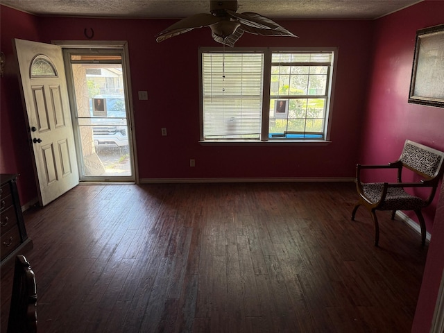 1130 Hoffman St, Houston, TX 77020 - foyer entrance featuring dark wood finished floors, a textured ceiling, a ceiling fan, and baseboards