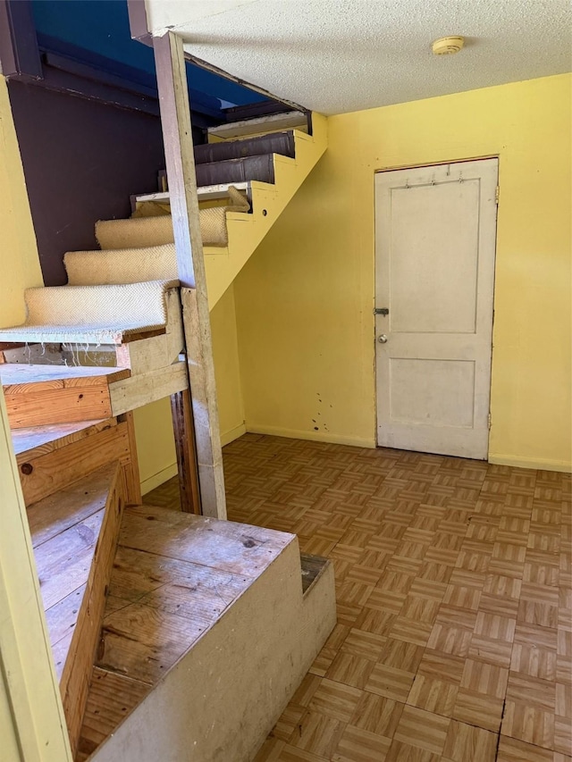 1130 Hoffman St, Houston, TX 77020 - staircase with baseboards and a textured ceiling