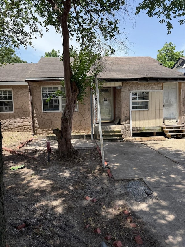 1130 Hoffman St, Houston, TX 77020 - view of front of house with stone siding, roof with shingles, and entry steps