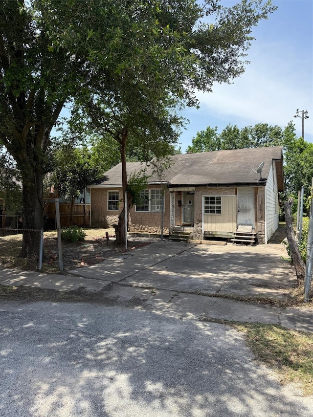 1130 Hoffman St, Houston, TX 77020 - view of front of house featuring fence, entry steps, roof with shingles, and driveway