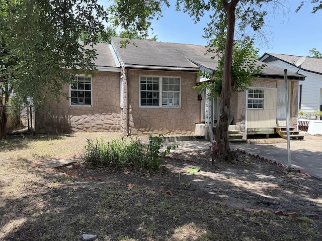 1130 Hoffman St, Houston, TX 77020 - view of front facade featuring stone siding, a shingled roof, and entry steps