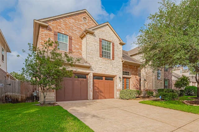 traditional-style home with a garage, a front lawn, fence, stone siding, and concrete driveway