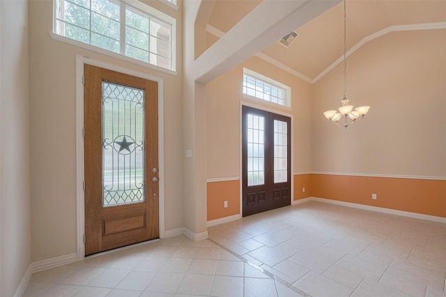 entrance foyer featuring high vaulted ceiling, a notable chandelier, and plenty of natural light