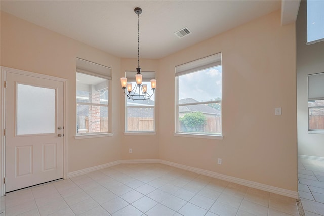 unfurnished dining area featuring visible vents, baseboards, a chandelier, and light tile patterned flooring