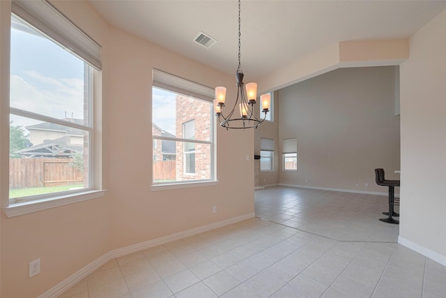 unfurnished dining area with visible vents, baseboards, a chandelier, and light tile patterned flooring