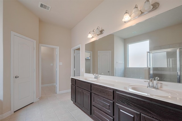 full bathroom with a sink, tile patterned floors, a stall shower, and visible vents