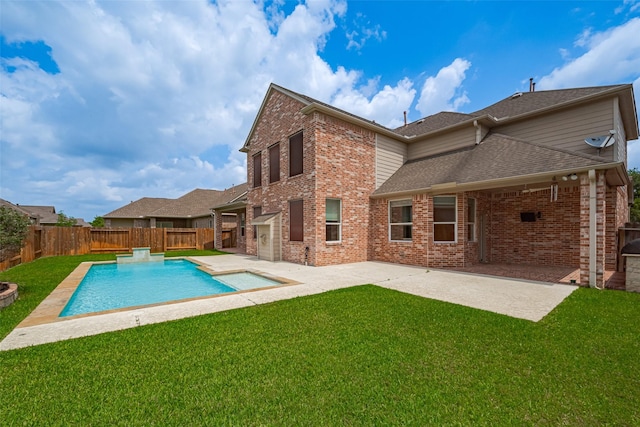 rear view of property featuring a yard, brick siding, a fenced backyard, and a patio area