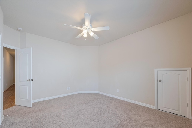 unfurnished room featuring a ceiling fan, baseboards, and carpet