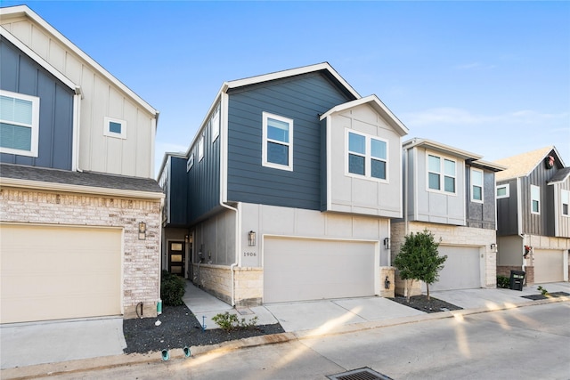 view of front of home featuring board and batten siding, an attached garage, concrete driveway, and stone siding