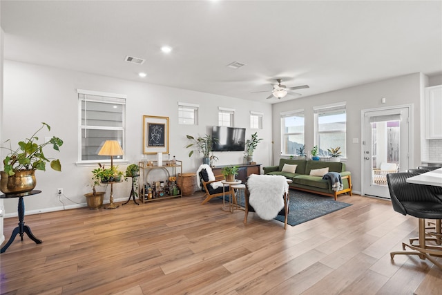 living area featuring visible vents, a ceiling fan, light wood-style floors, and recessed lighting