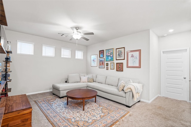 living area featuring baseboards, ceiling fan, carpet, and visible vents