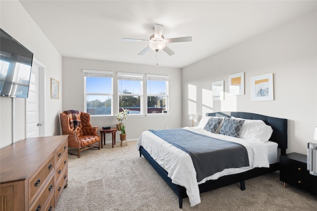 bedroom featuring ceiling fan and light carpet