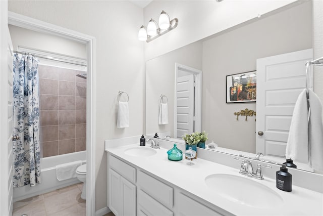 bathroom featuring double vanity, toilet, shower / bath combination with curtain, and a sink